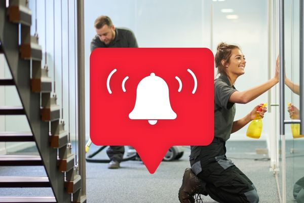 7 Signs Of A Bad Commercial Cleaners - Cleaners working in office space with alarm bell icon over the top.